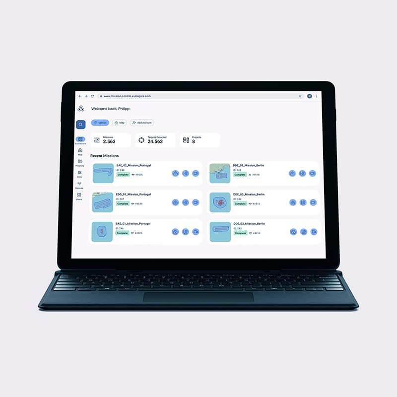 Laptop screen displaying a mission control dashboard with mission statistics and recent missions listed, including locations in Portugal and Berlin.