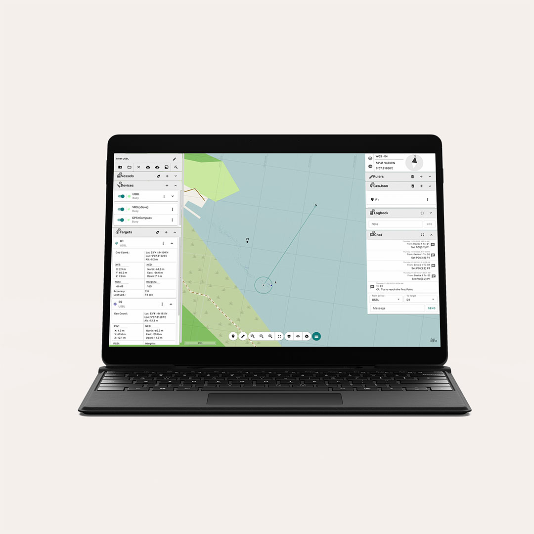 Laptop displaying a marine navigation software interface with map, vessel tracking, and communication panels.