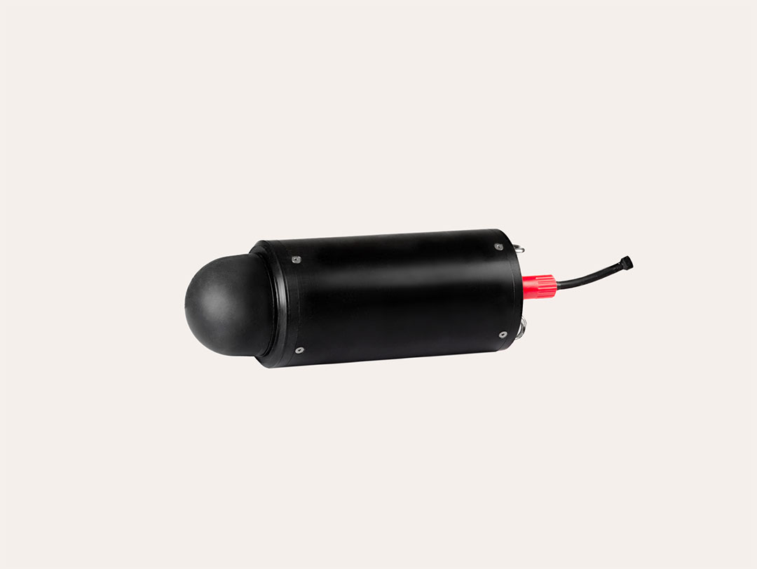 Black cylindrical underwater device with a rounded dome front and red connector with cable at the back on a white background.