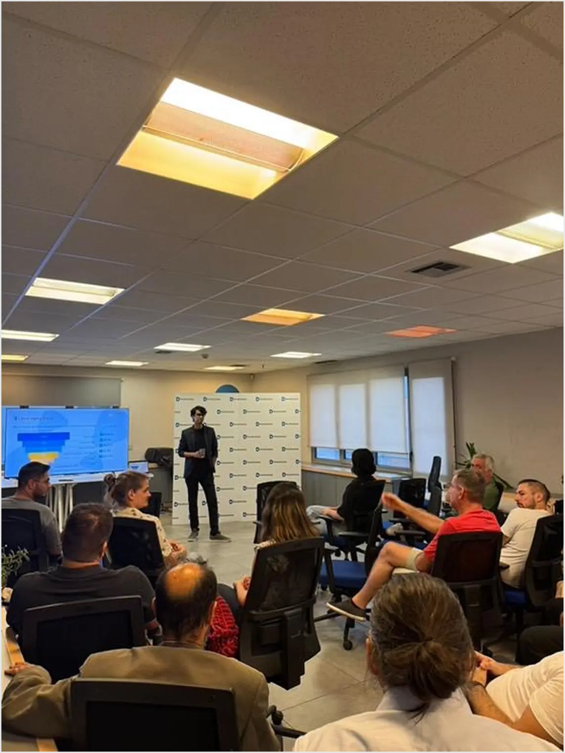 Team photo of Product People, a leading product management consulting company, smiling and gathered in the office.