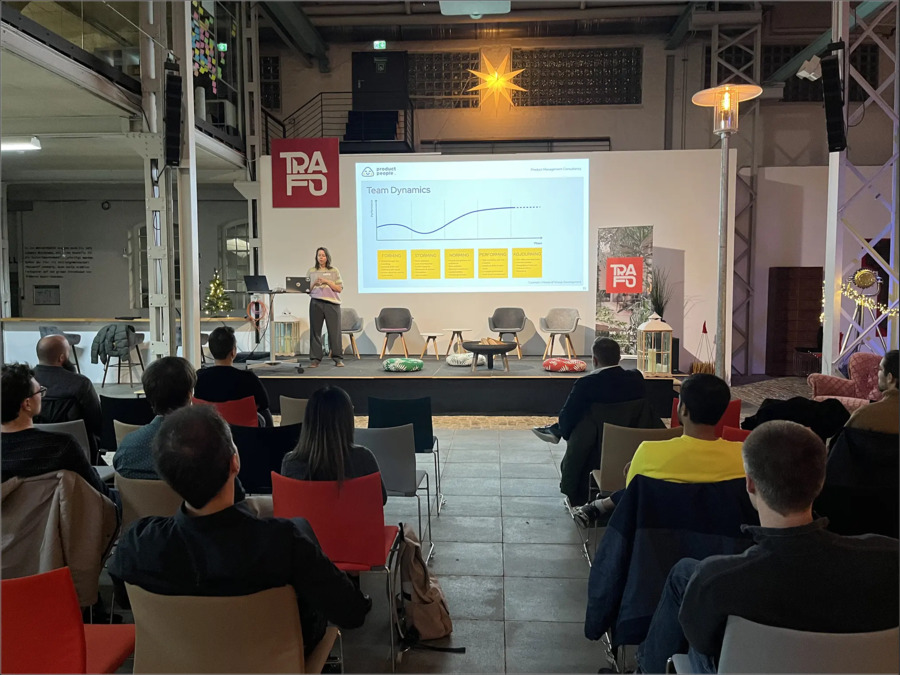 Image of people talking from an offline event by Product People, a product strategy consulting firm.