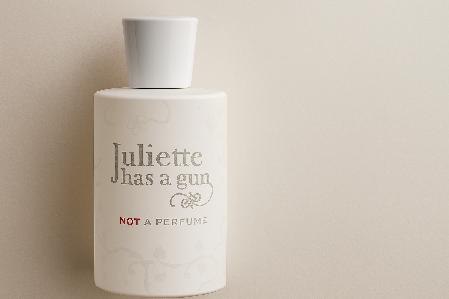A digital photograph showcases a cylindrical white bottle of "Juliette Has a Gun – Not a Perfume" against a soft beige background.