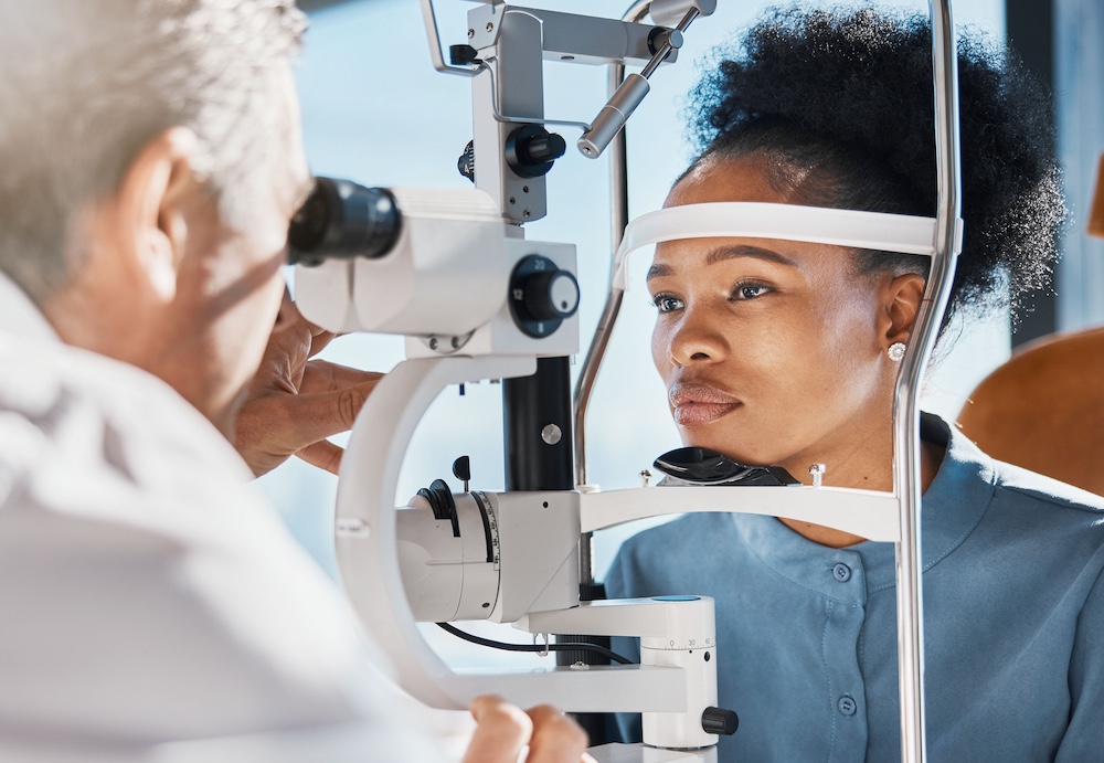 Eye doctor performing eye exam using professional medical equipment