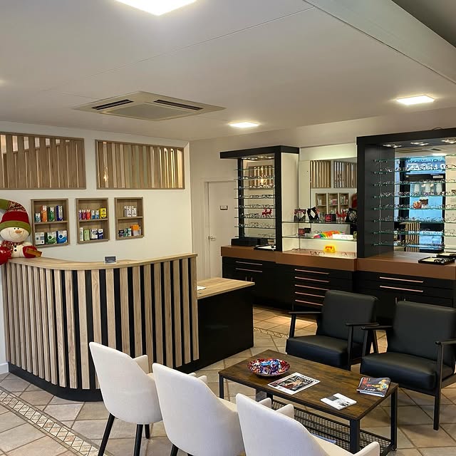 Modern optical store interior with reception desk, display shelves, and seating area