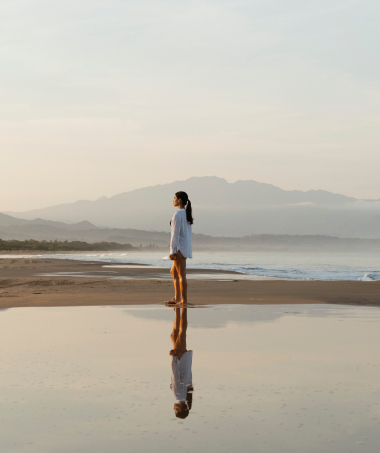 A woman standing on the beach
