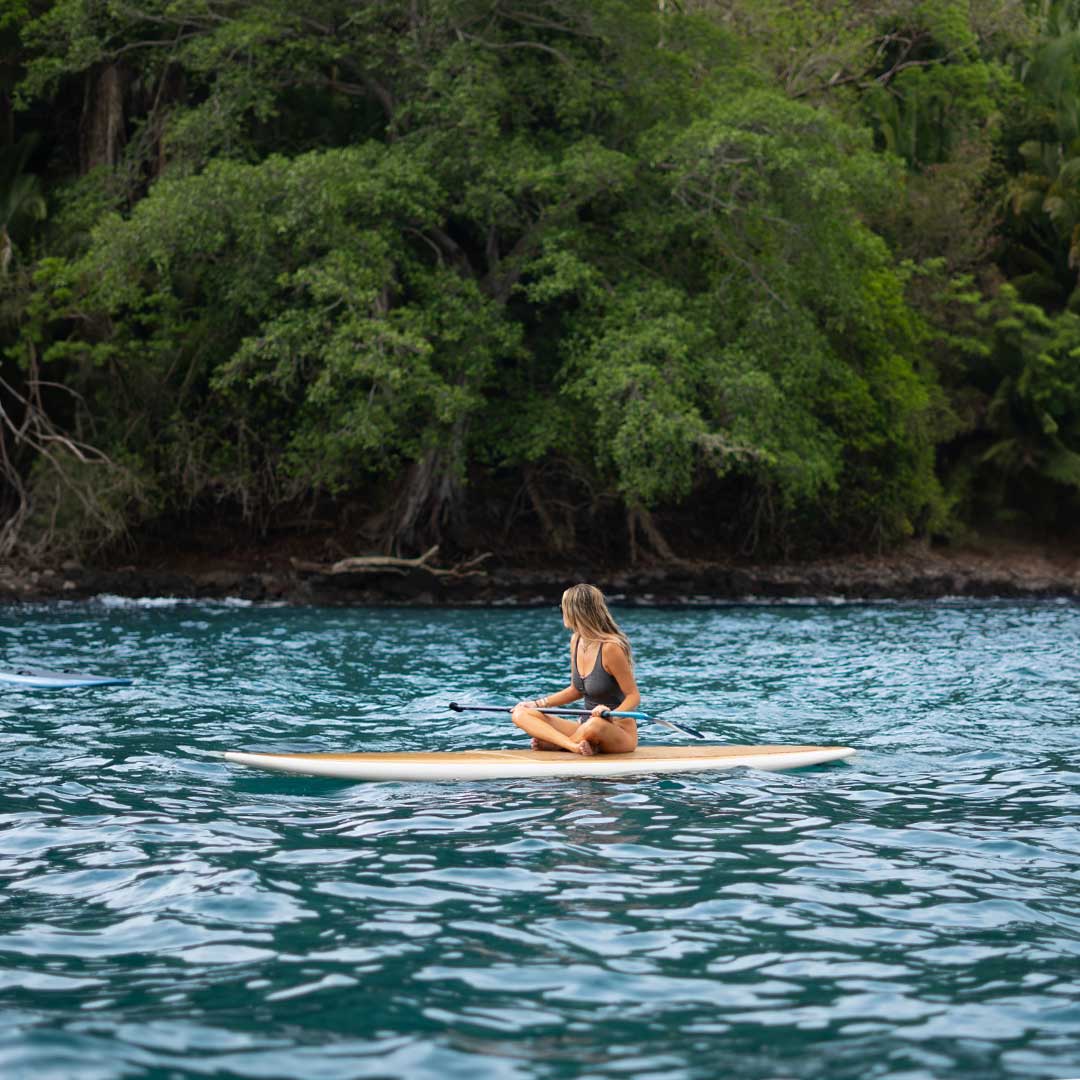 Woman paddle boarding on the ocean