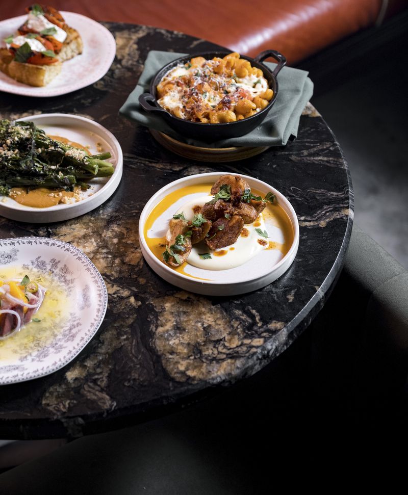 Small plates on a dark marble restaurant table