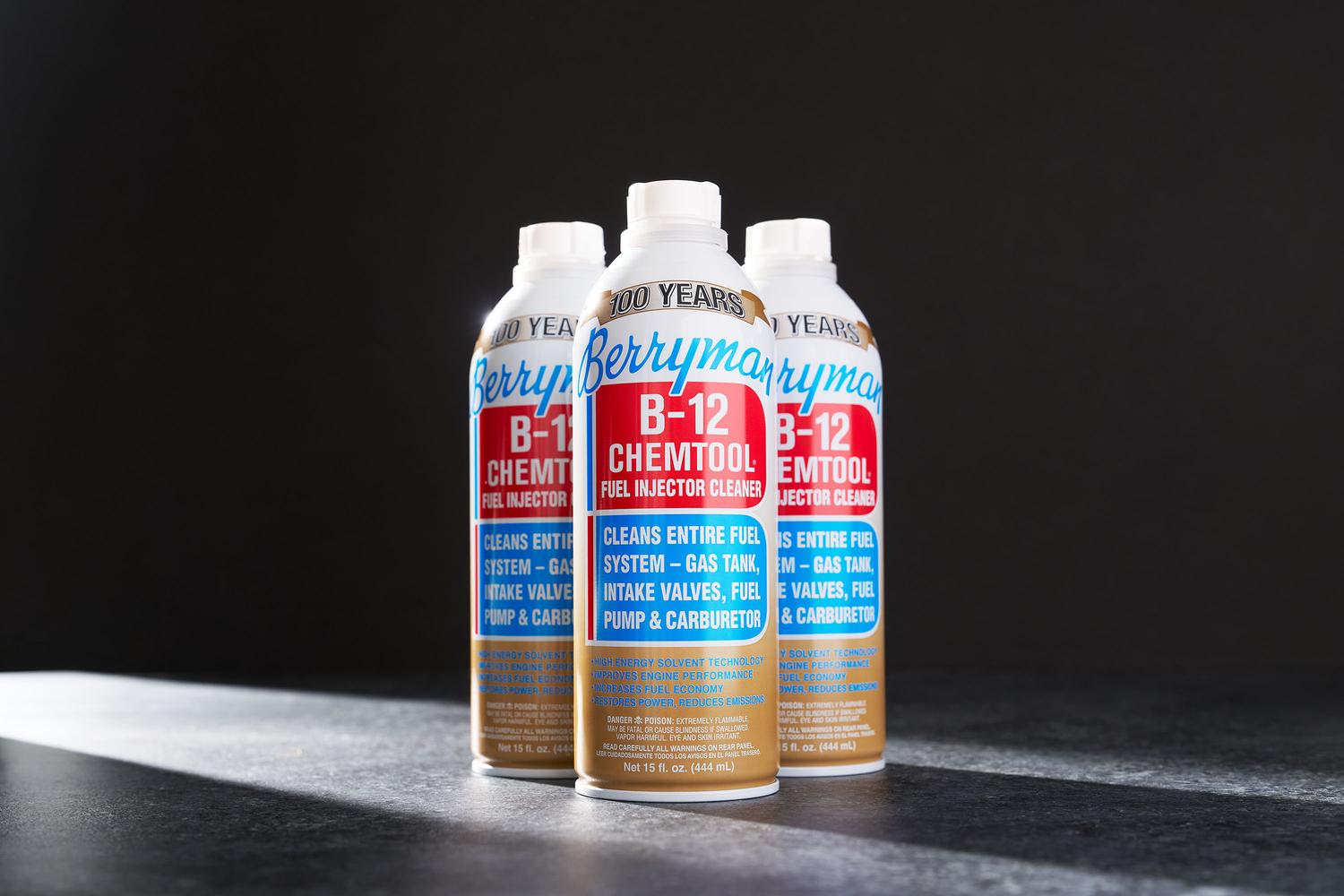 Three white aerosol cans of Berryman B-12 Chemtool Fuel Injector Cleaner positioned on a gray surface against a black background. The bottles feature prominent red and blue labels with gold accents and '100 Years' branding at the top.
