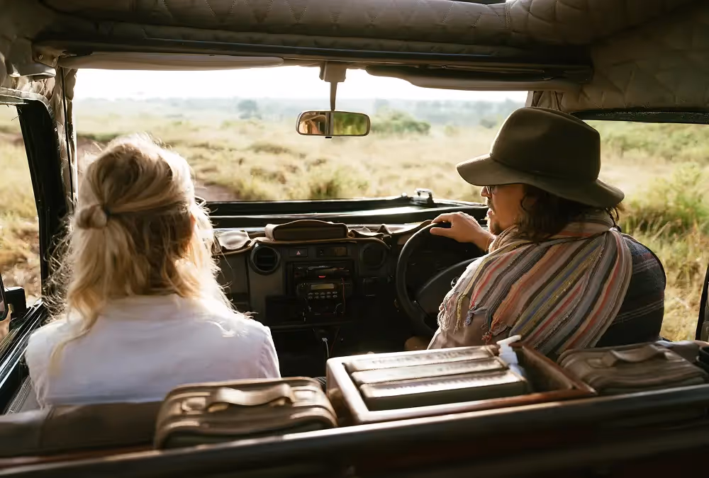 People in front seats of guide vehicle