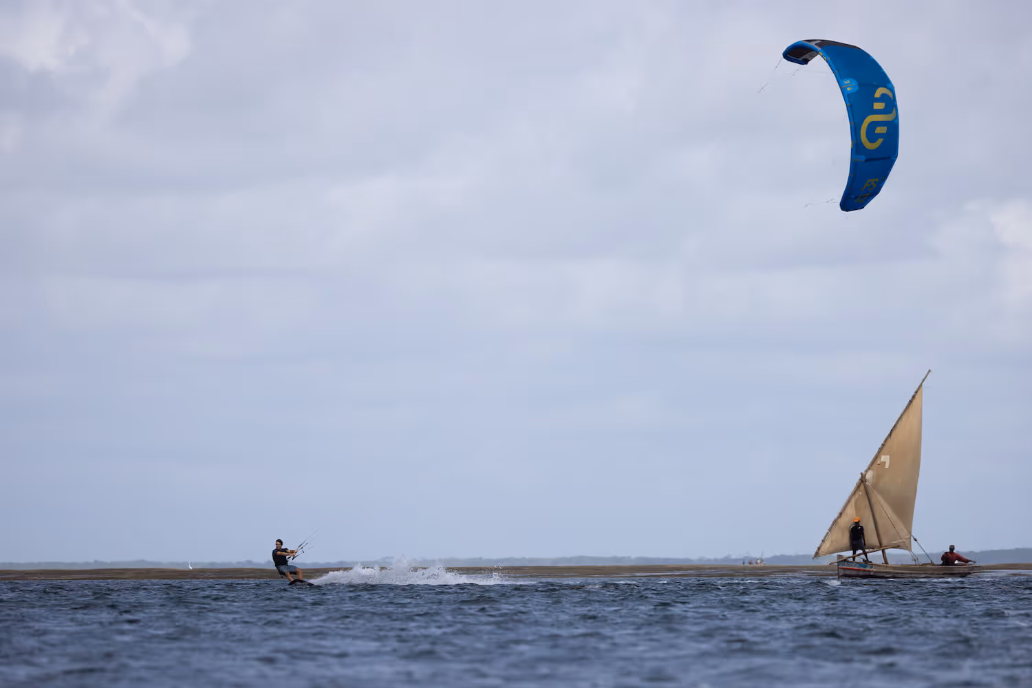 Kite surfing in front of a dhow
