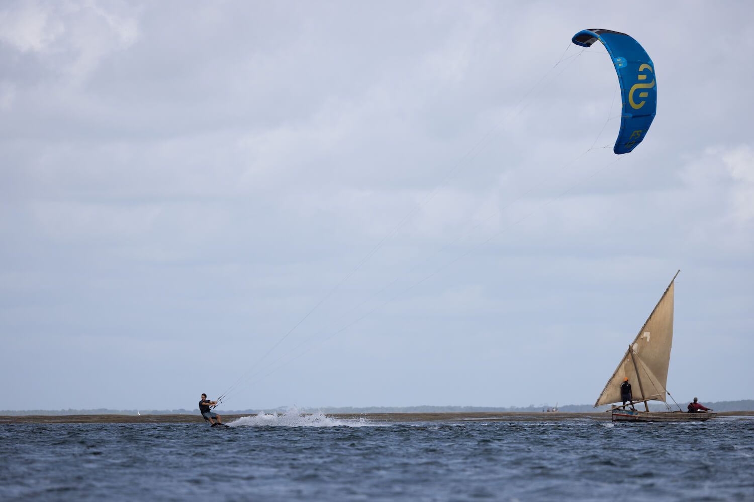 Kite surfing in front of a dhow
