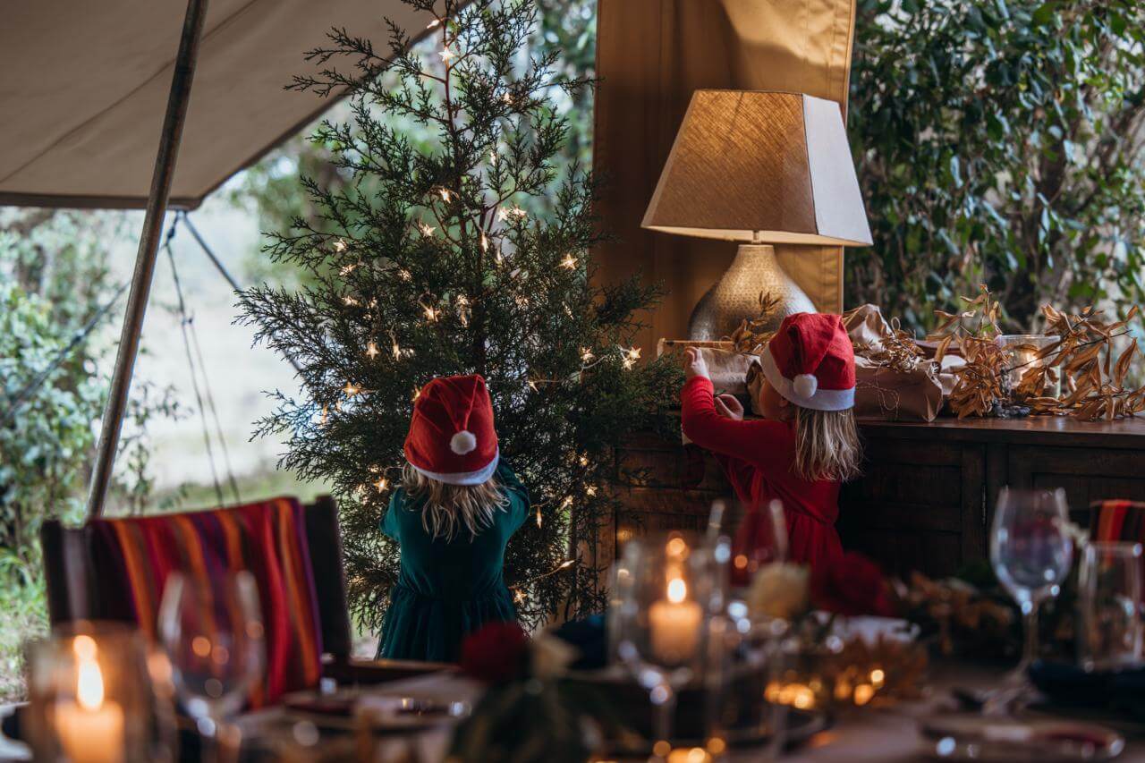 Girls around a Christmas tree in camp