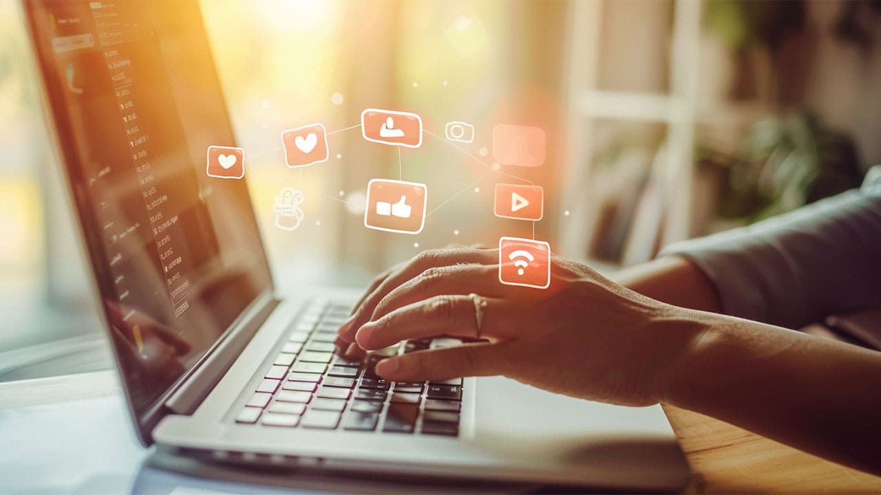 e-commerce brand business owner typing on a laptop representing happy customers
