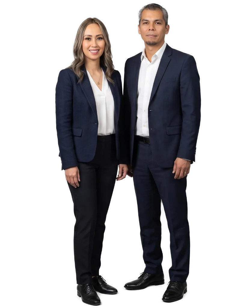 Full-body portrait of NewGen Cleaning Services founders Kathleen (President & GM) and Charles, standing professionally in tailored suits | NewGen Cleaning Services
