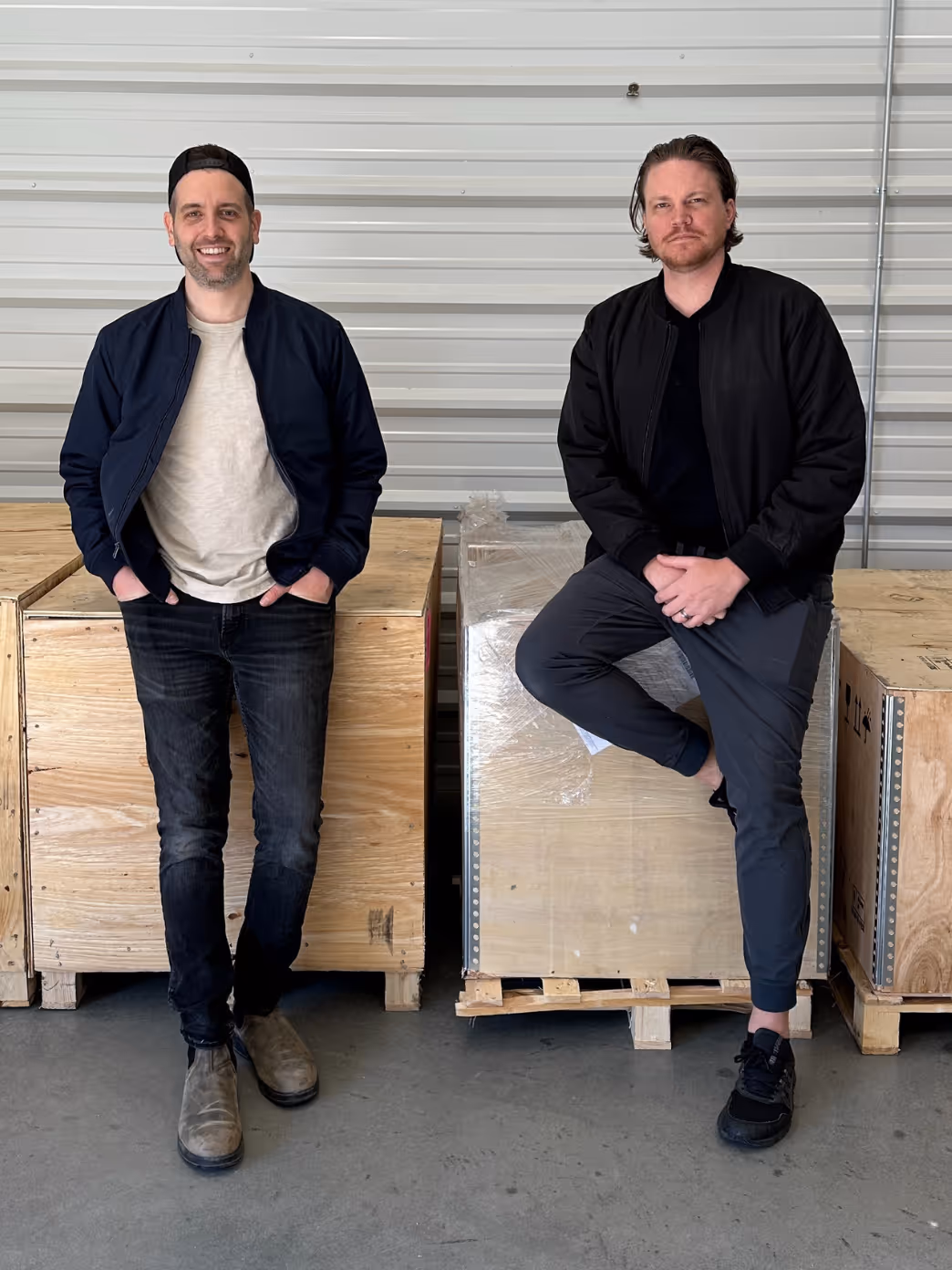 Marc and Mark standing in front of a shipping crate