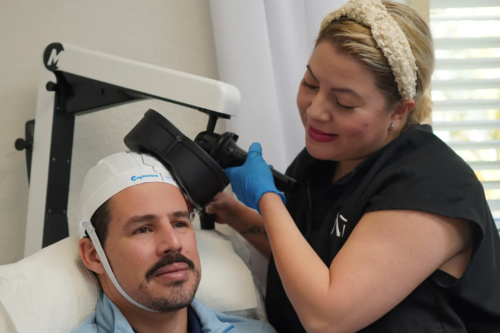 Clínica colocando la bobina de terapia TMS para la depresión a un paciente en ARC Mental Health