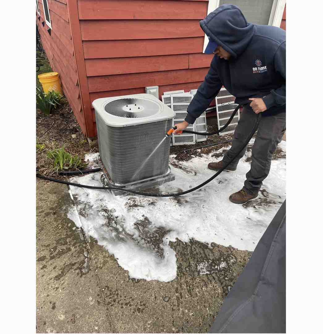 technician cleaning an outdoor AC unit - affordable hvac tune-up oconomowoc wi technician cleaning an outdoor AC unit - affordable hvac tune-up oconomowoc wi