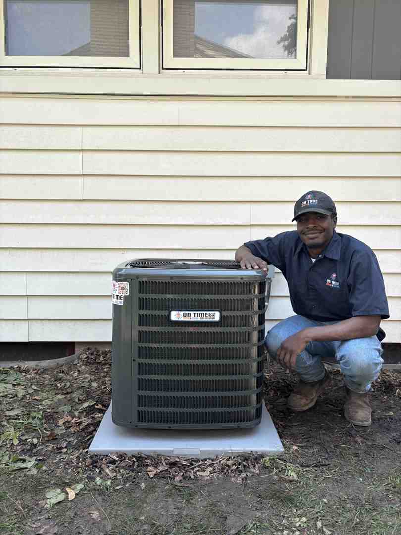 HVAC technician smiling - heat pump replacement sussex wi