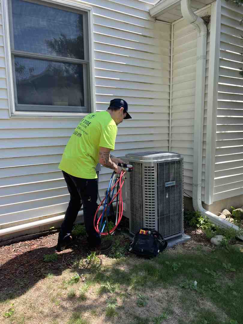 Professional technician diagnosing an outdoor AC unit - air conditioner not cooling new berlin wi