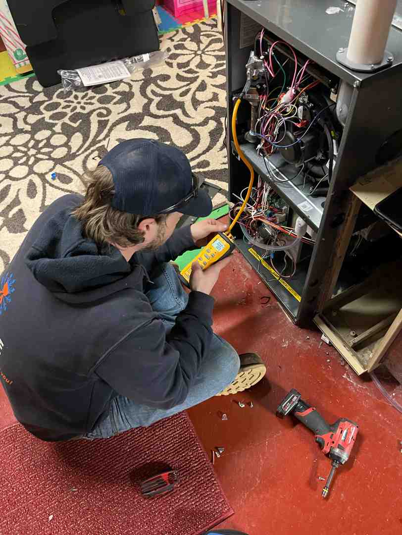 image of a technician diagnosing a furnace problem - emergency furnace replacement delafield wi image of a technician diagnosing a furnace problem - emergency furnace replacement delafield wi