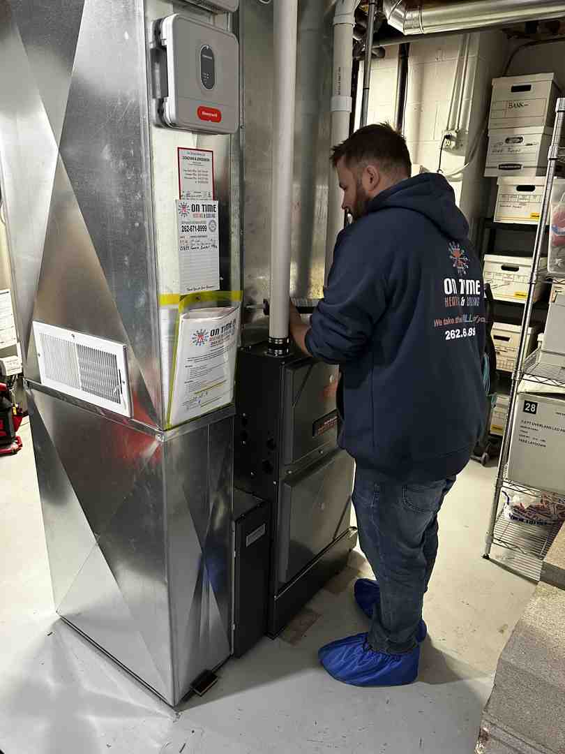 technician performing furnace tune-up - furnace maintenance and repair lannon