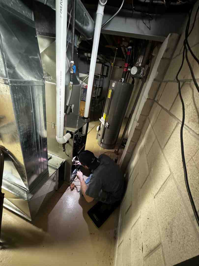 HVAC technician inspecting furnace - heating system not working sussex wi HVAC technician inspecting furnace - heating system not working sussex wi