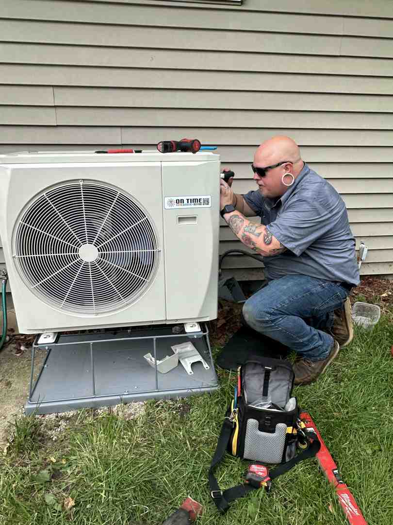 professional technician carefully installing an outdoor heat pump unit - energy efficient heat pump oconomowoc wi professional technician carefully installing an outdoor heat pump unit - energy efficient heat pump oconomowoc wi