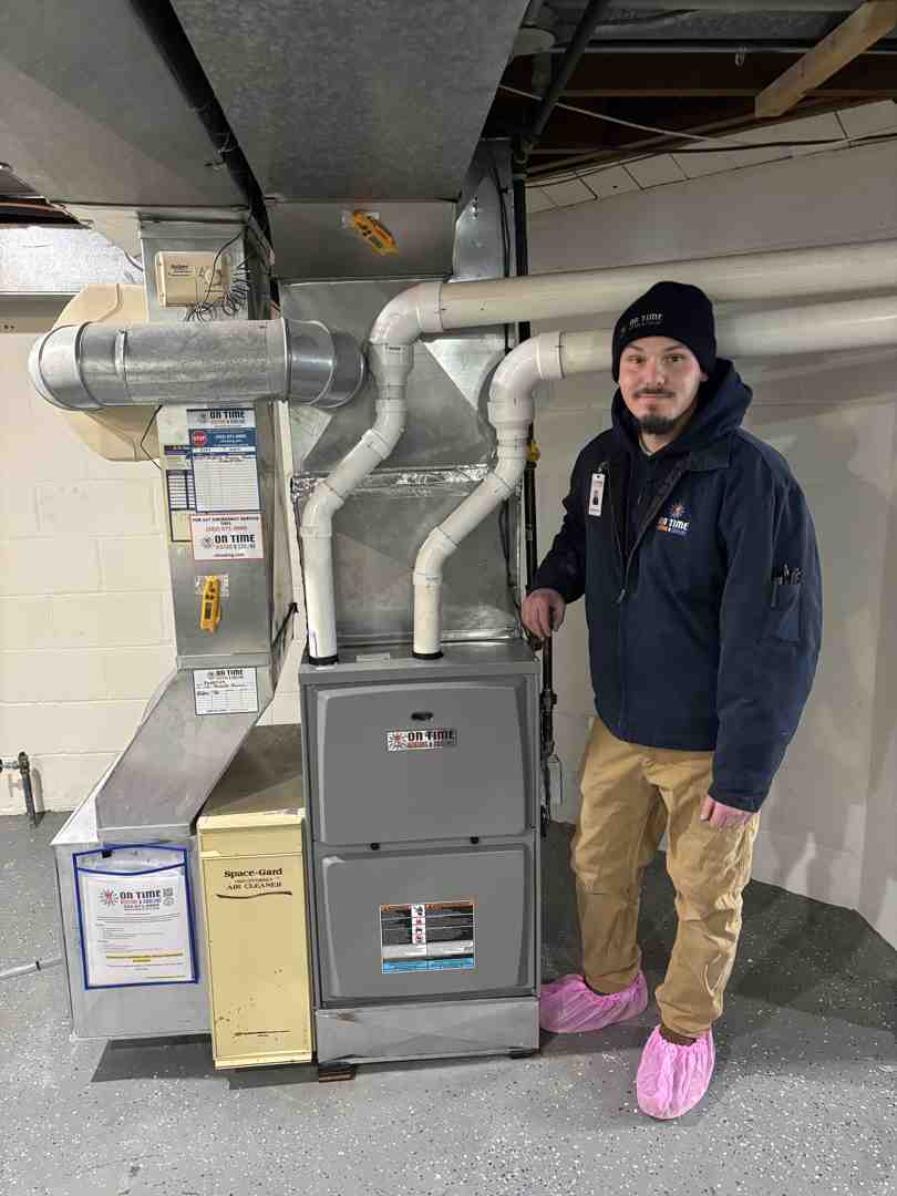 a certified technician carefully installing a new gas furnace - gas heating installation pewaukee a certified technician carefully installing a new gas furnace - gas heating installation pewaukee