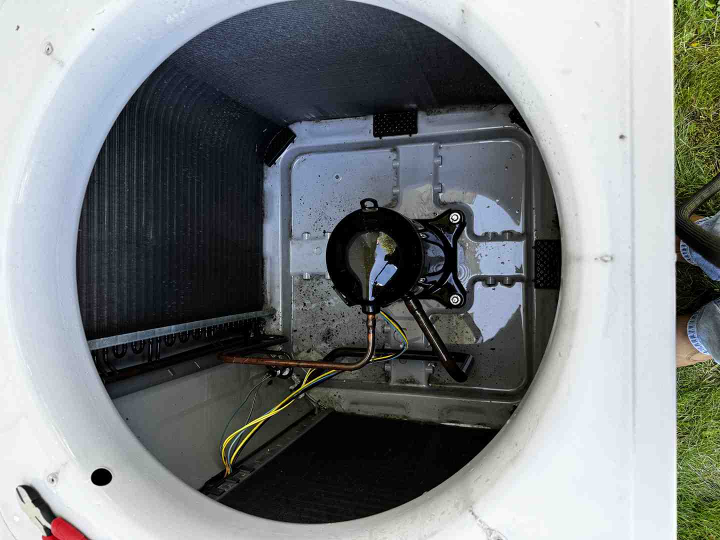 technician working on an open AC unit's internal components - air conditioner repair technician working on an open AC unit's internal components - air conditioner repair