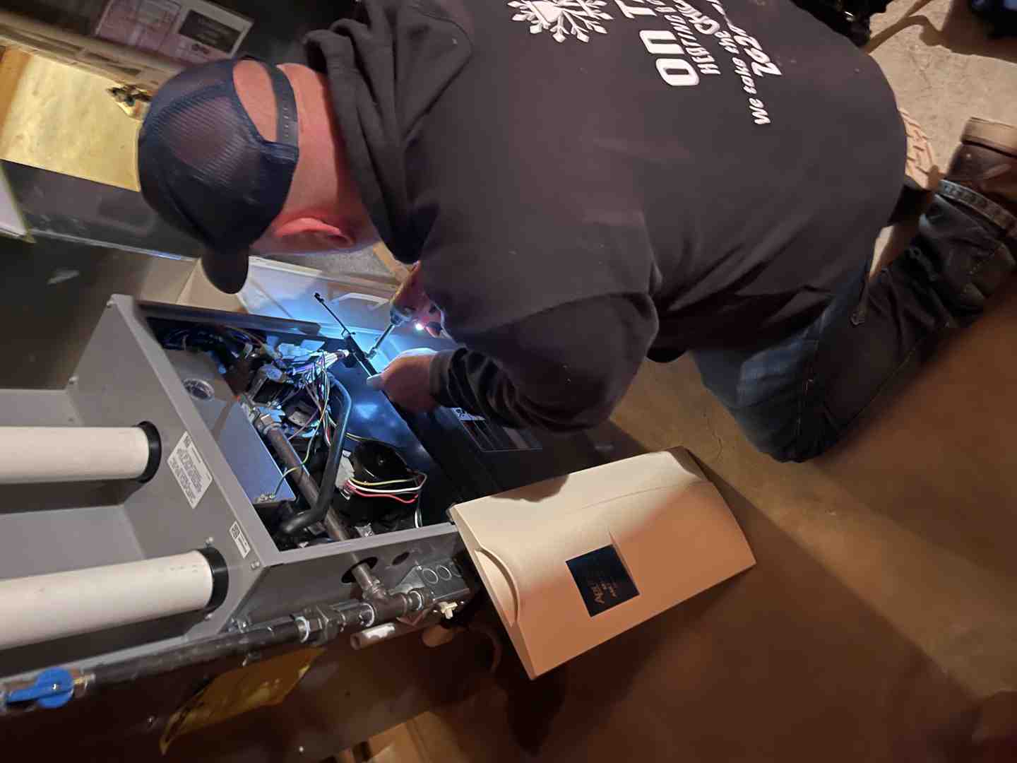 professional technician carefully inspecting a furnace unit - best furnace maintenance in brookfield, wi