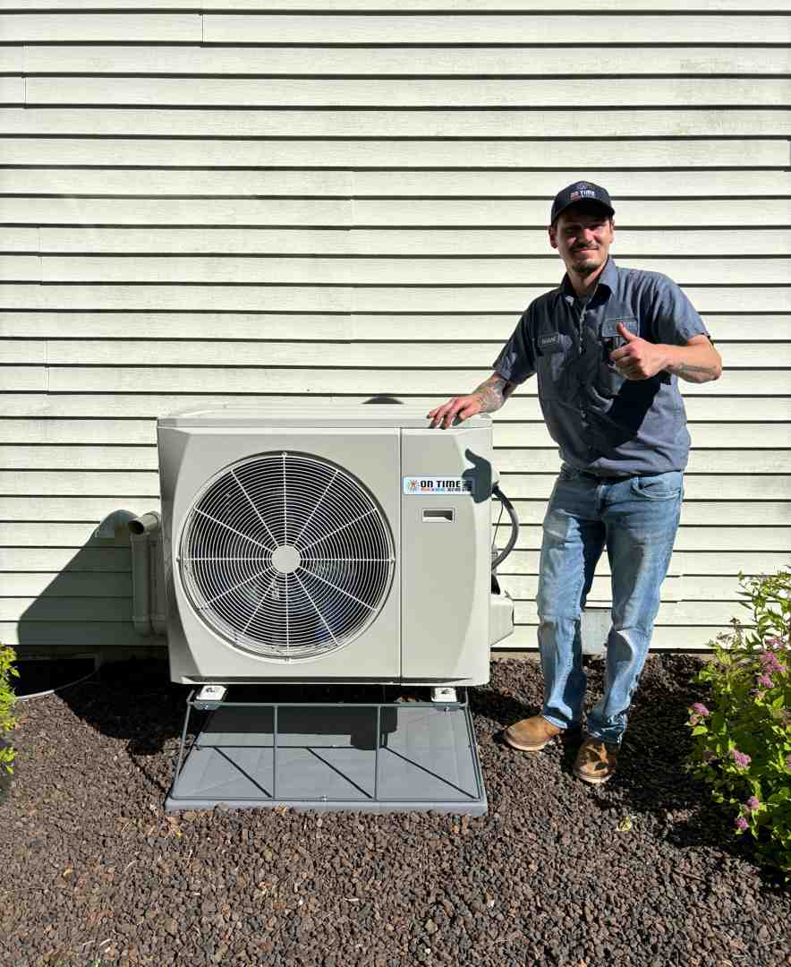 Professional friendly technician servicing outdoor heat pump unit - best heat pump repair in brookfield, wi