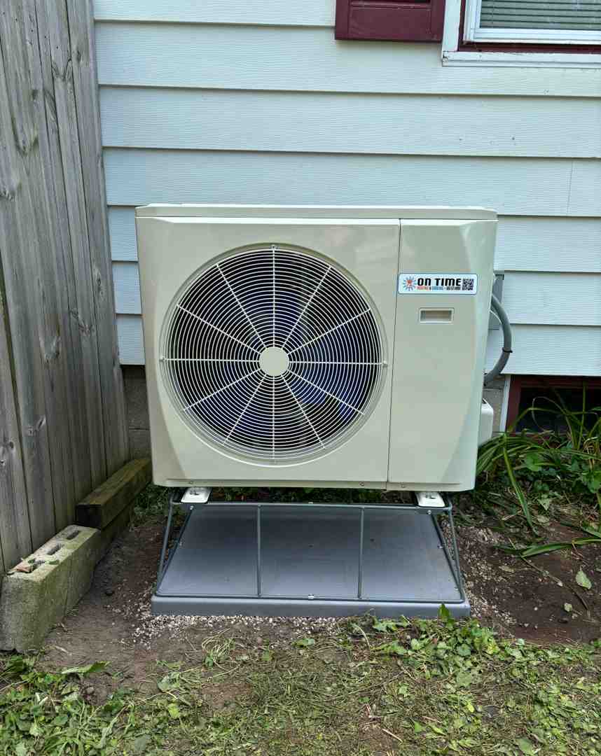 heat pump installed outside a home in winter - how does a heat pump work