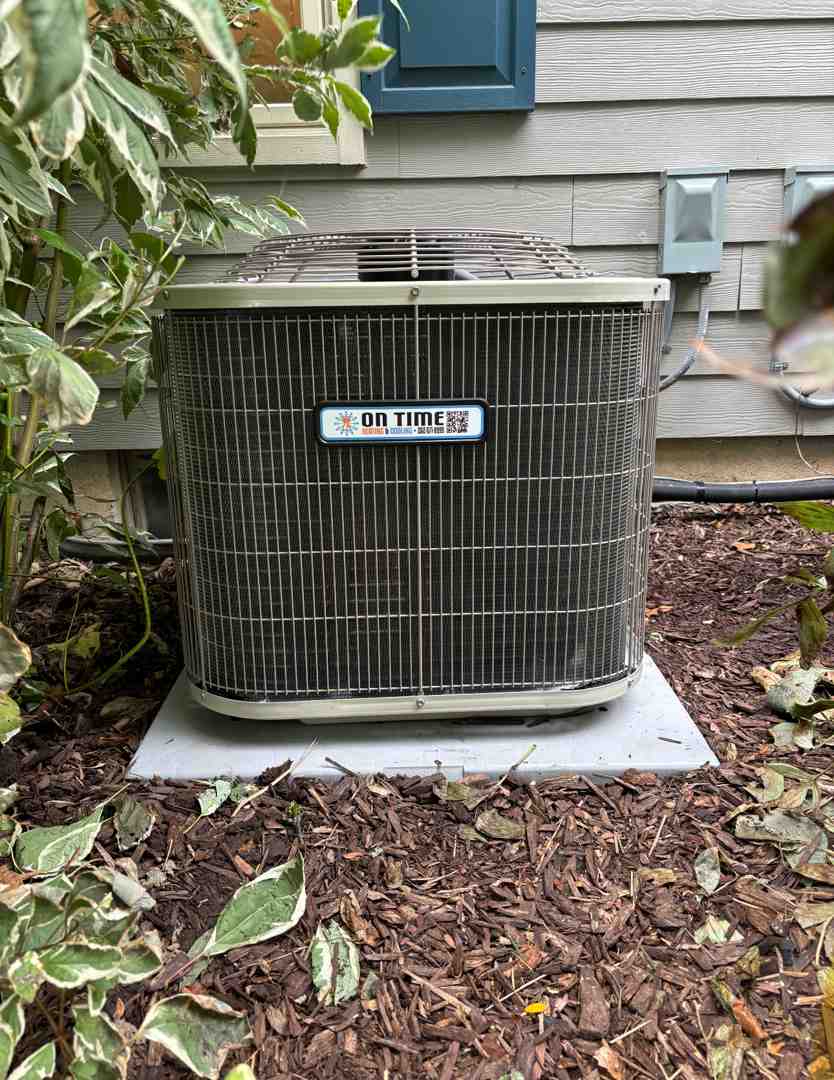 Outdoor air conditioner condenser unit operating in summer heat
