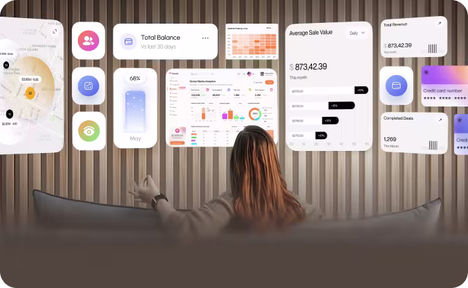 Person sitting on couch interacting with multiple floating digital data dashboards and charts.