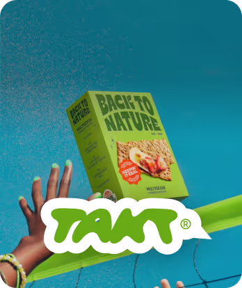 Hands reaching for a green box of Back to Nature Multi-Seed Crisps against a blue sky.