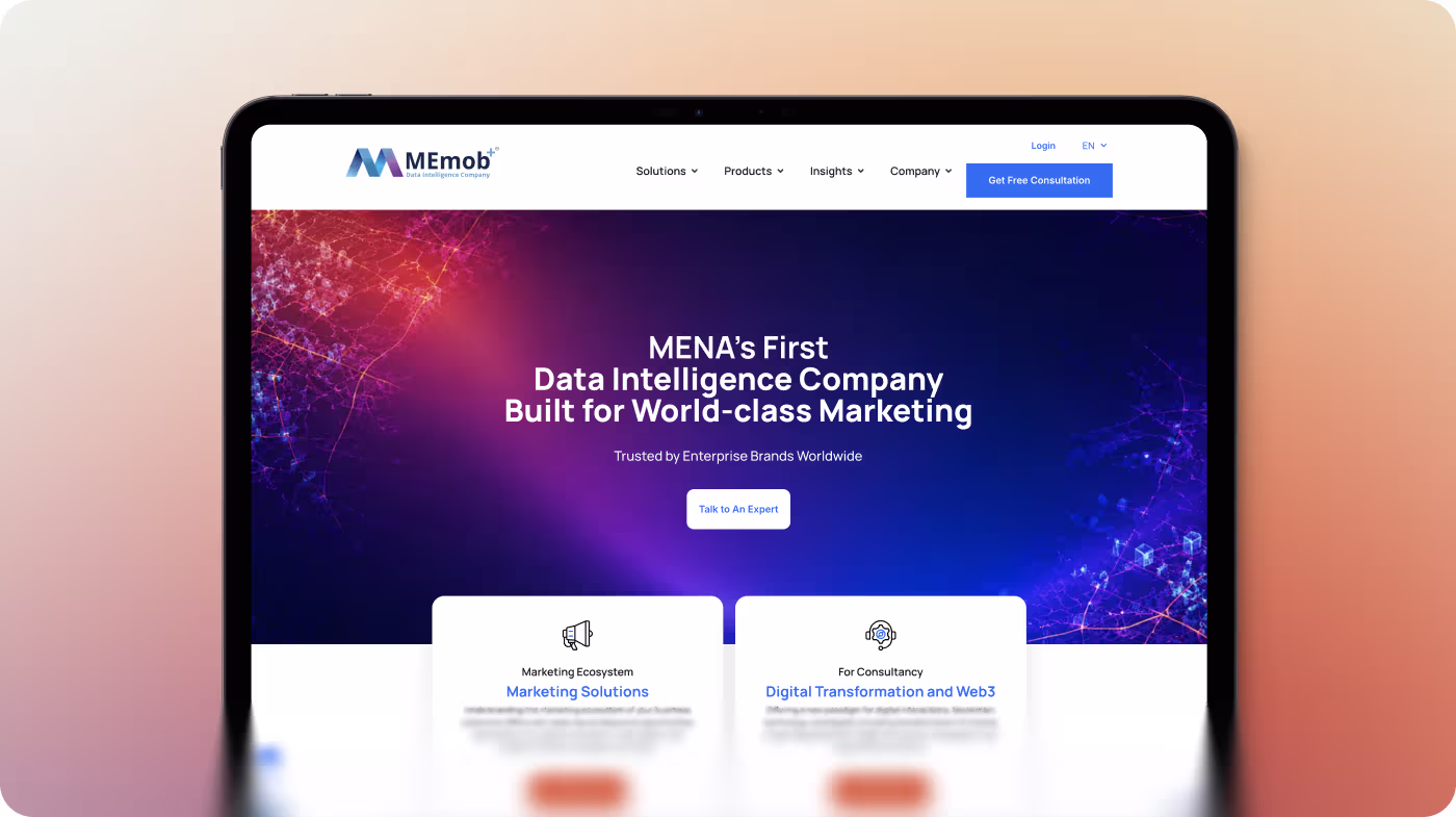 Tablet showing MEMob website homepage with marketing and digital transformation service options.