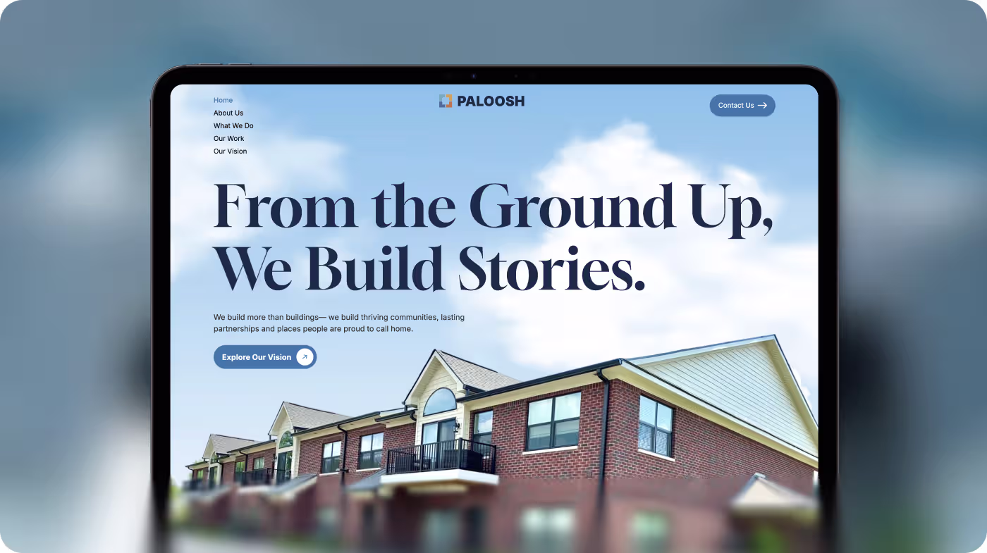 Tablet screen showing a website homepage with a brick apartment building under a cloudy blue sky.