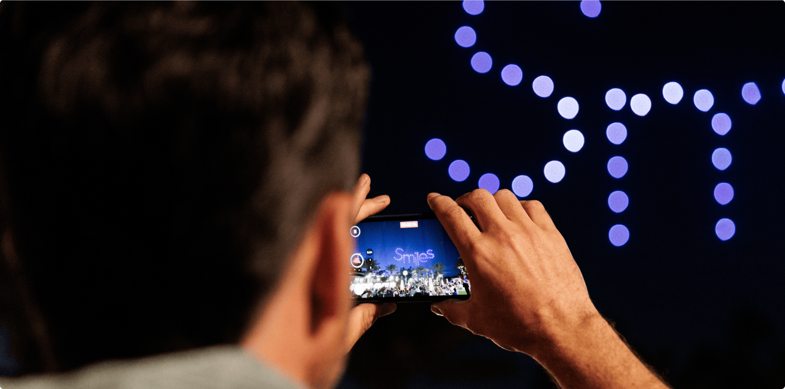 Attendee taking photo of drone show
