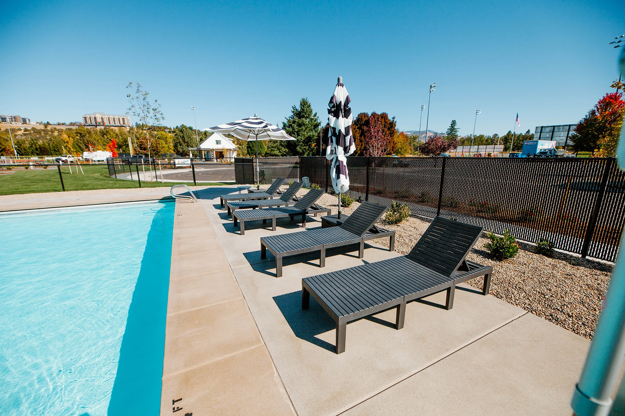 Lounge chairs and swimming pool at Mr. Bigfoot RV Park 