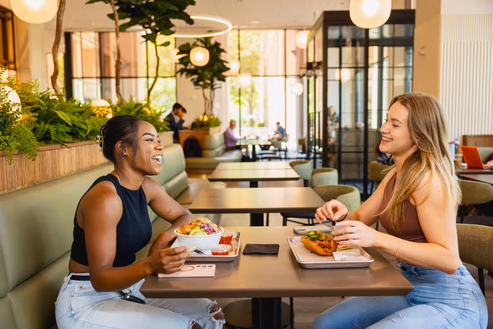 Two ladies sitting down to eat in Park Square 