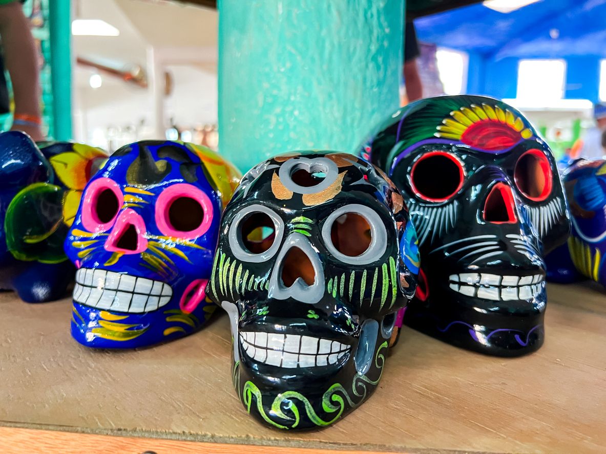 Three painted skulls in row of varying 