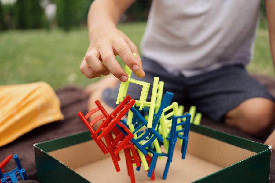 A young child stacking a toy, representing early math play