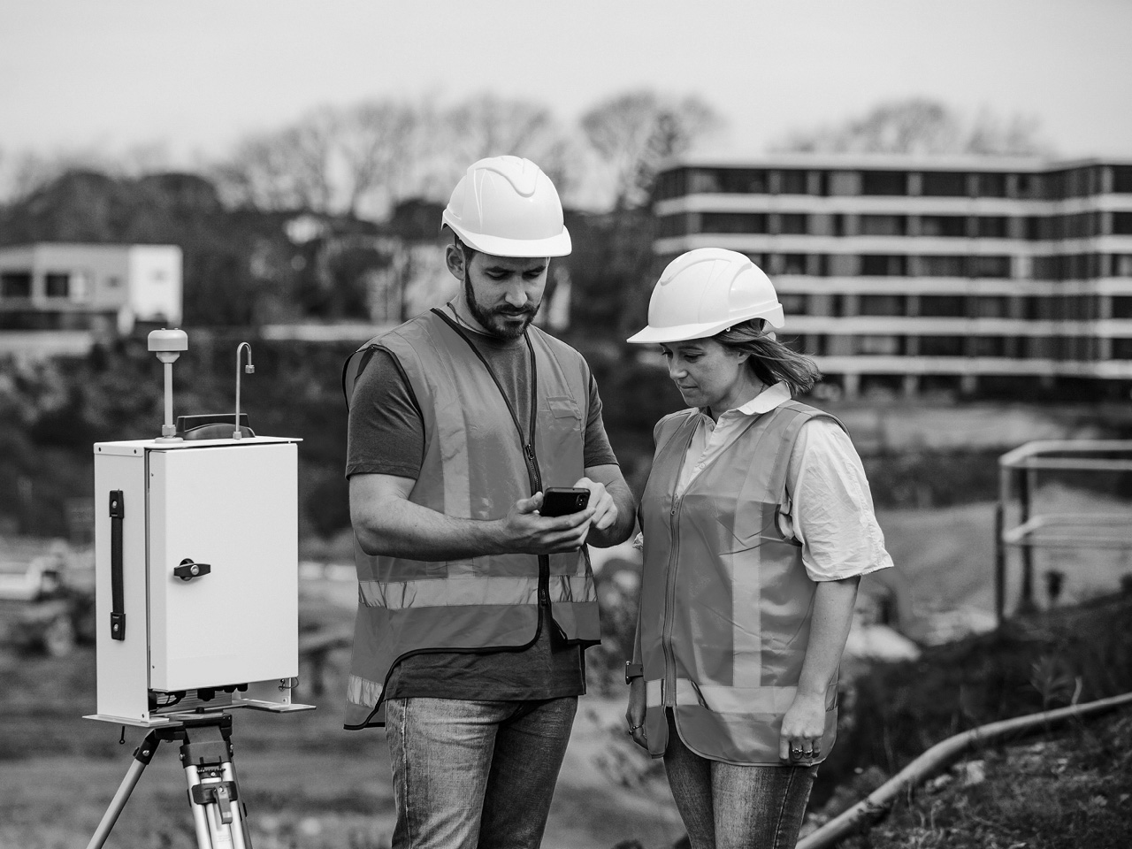 Two workers checking phone