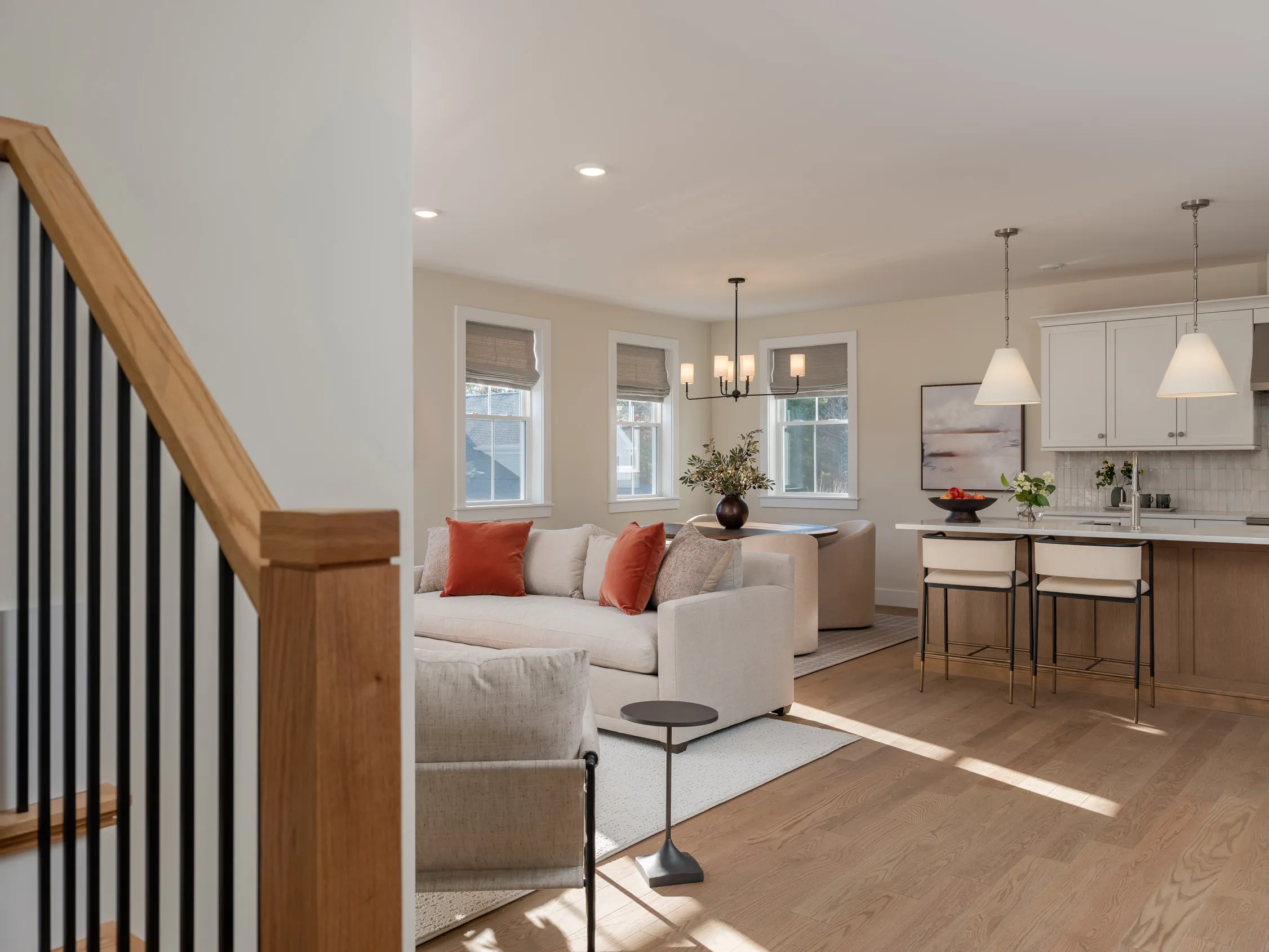 (title) Open-Plan Living Room (description) Light-filled open-plan living at Alden's Reach — new construction homes in Plymouth, MA featuring hardwood floors and expansive windows.