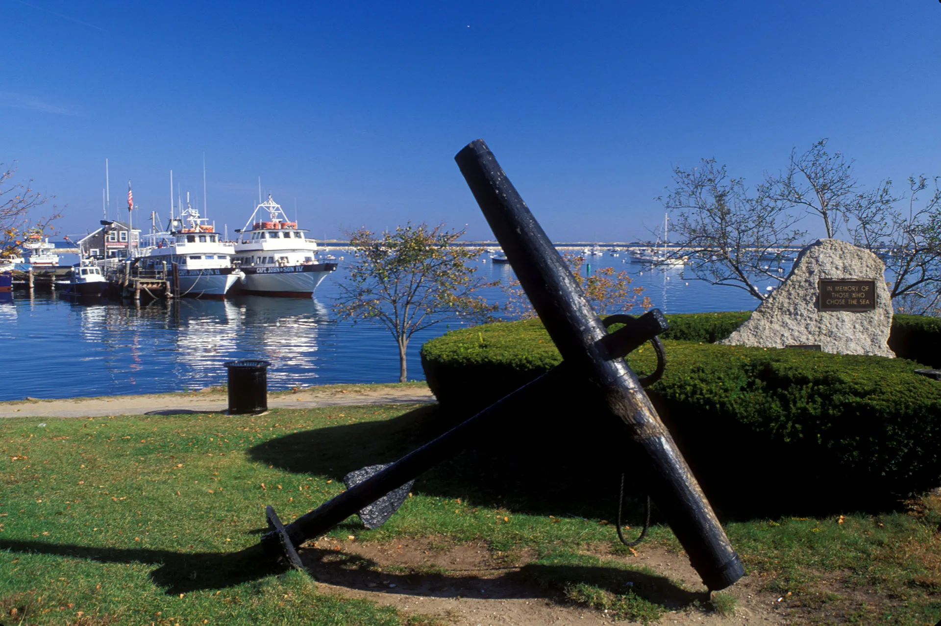 Plymouth Harbor anchor monument and fishing boats near Alden's Reach new homes in Plymouth MA