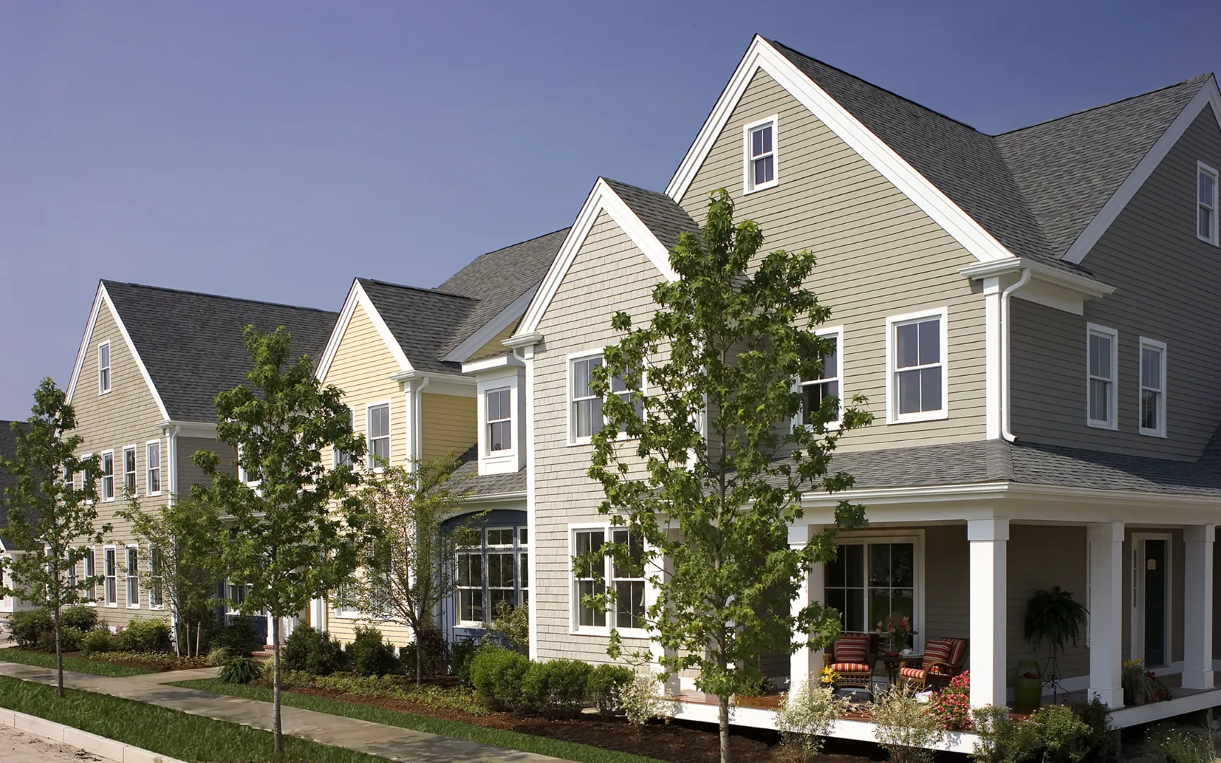 Traditional New England townhomes with front porches at Red Mill Village in Norton MA