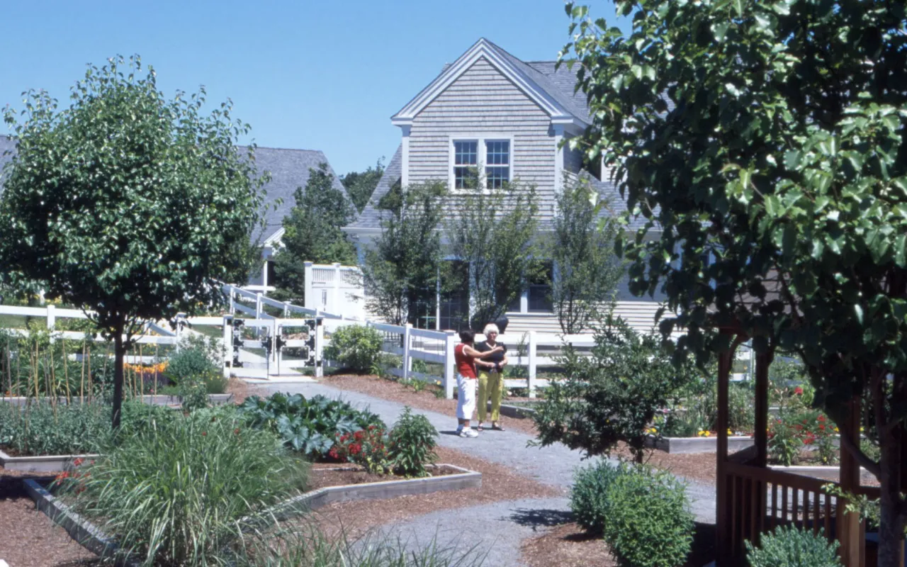 Homeowners strolling through Victory Gardens at GreatBrook active adult neighborhood Norton MA