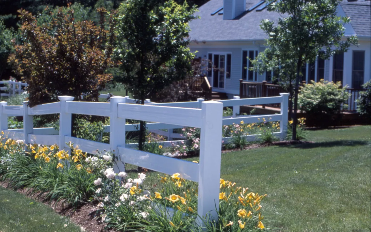 Perennial flower beds along white fence at GreatBrook Thorndike Development in Norton MA