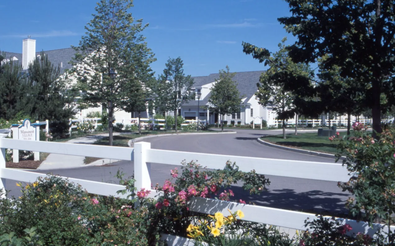 Rose-lined intersection at GreatBrook active adult community entrance in Norton MA