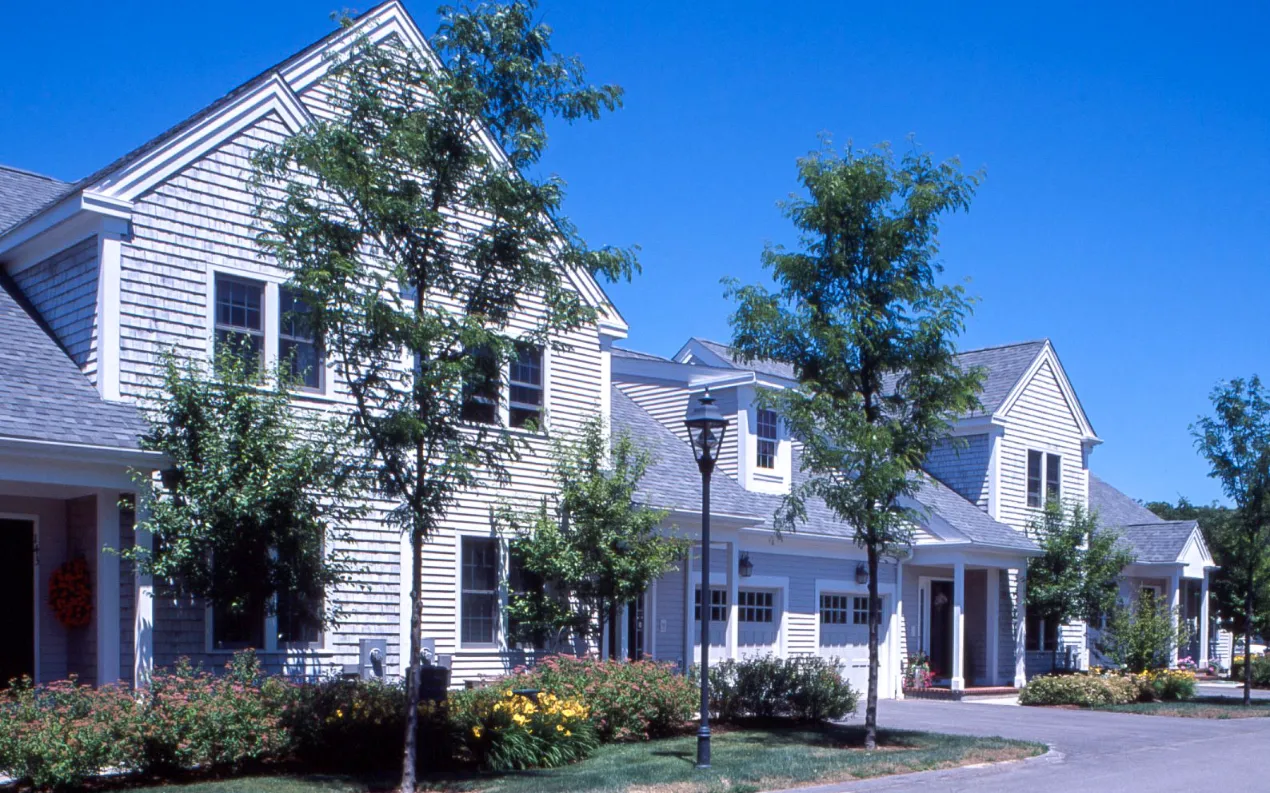 Classic New England attached homes on a sunny day at GreatBrook in Norton Massachusetts